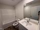Bright bathroom featuring a tub-shower combo, toilet, and a single sink vanity with a large mirror at 8 W Emily Gardens Dr, Selma, NC 27576