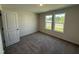 Cozy bedroom with plush carpeting, neutral walls, and large windows overlooking the neighborhood at 8 W Emily Gardens Dr, Selma, NC 27576