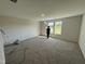 Bright bedroom with plush carpeting and large windows offering serene views at 8 W Emily Gardens Dr, Selma, NC 27576