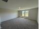 Comfortable bedroom with plush carpeting and ample natural light from the window, offering a cozy retreat at 8 W Emily Gardens Dr, Selma, NC 27576