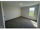 Cozy bedroom with neutral walls, carpeted floors, and a large window, creating a peaceful atmosphere at 8 W Emily Gardens Dr, Selma, NC 27576