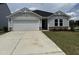 Charming single-story home featuring a two-car garage and well-maintained lawn at 8 W Emily Gardens Dr, Selma, NC 27576