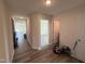 Inviting hallway with wood-look flooring leading to various rooms of the house at 8 W Emily Gardens Dr, Selma, NC 27576