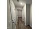 Clean hallway with neutral walls and vinyl flooring, great for access to other areas in the house at 8 W Emily Gardens Dr, Selma, NC 27576