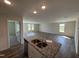 Bright, open-concept kitchen with granite countertops, stainless steel appliances, and views of the living area at 8 W Emily Gardens Dr, Selma, NC 27576