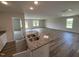 Open-concept space featuring a kitchen with granite countertops and stainless steel sink at 8 W Emily Gardens Dr, Selma, NC 27576