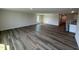 Open-concept living room with hardwood flooring, natural light, and neutral paint, creating a welcoming atmosphere at 8 W Emily Gardens Dr, Selma, NC 27576