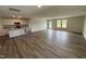 Open living area with hardwood floors, seamlessly connecting the kitchen and living room at 8 W Emily Gardens Dr, Selma, NC 27576