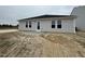 New construction home exterior featuring a freshly poured patio and vinyl siding at 8 W Emily Gardens Dr, Selma, NC 27577