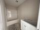 Bathroom featuring a shower and a vanity with white cabinets, neutral walls, and unfinished flooring at 8 W Emily Gardens Dr, Selma, NC 27577