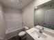 Clean bathroom featuring white fixtures, a bathtub-shower combo, and a spacious single sink vanity at 8 W Emily Gardens Dr, Selma, NC 27577