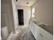 Bathroom featuring a shower and a vanity with white cabinets, neutral walls, and unfinished flooring at 8 W Emily Gardens Dr, Selma, NC 27577
