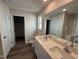 Bathroom featuring dual sinks, a large mirror, white cabinets, and modern fixtures at 8 W Emily Gardens Dr, Selma, NC 27577