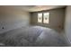Bedroom featuring neutral walls, unfinished floors, double windows and unfinished lighting at 8 W Emily Gardens Dr, Selma, NC 27577
