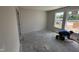 A construction worker installs floor trim in a bedroom with two windows at 8 W Emily Gardens Dr, Selma, NC 27577