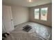 Bedroom with carpet flooring and two windows providing natural light at 8 W Emily Gardens Dr, Selma, NC 27577