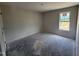 Bright bedroom with a neutral color palette and bare concrete flooring at 8 W Emily Gardens Dr, Selma, NC 27577