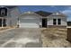 Charming single-story home featuring a two-car garage and stone accents at 8 W Emily Gardens Dr, Selma, NC 27577