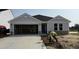 Charming single-Gathering home featuring stone accents, a two-car garage and landscaping in progress at 8 W Emily Gardens Dr, Selma, NC 27577
