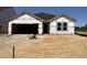 New home under construction with Barricade building wrap and a dark shingled roof ready for customization at 8 W Emily Gardens Dr, Selma, NC 27577