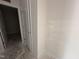 View of a hallway with a door leading into a room with a neutral color scheme at 8 W Emily Gardens Dr, Selma, NC 27577