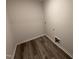 Laundry room with tile floors, utility connections, and a small access door at 8 W Emily Gardens Dr, Selma, NC 27577
