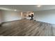 Open-concept living room featuring wood-look floors, recessed lighting and an island with a sink at 8 W Emily Gardens Dr, Selma, NC 27577
