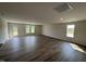 Spacious living room with dark wood floors, recessed lighting, and a back door to the outside at 8 W Emily Gardens Dr, Selma, NC 27577