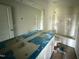 Bathroom featuring double sink vanity, mirror, and bathtub with shower at 82 W Emily Gardens Dr, Selma, NC 27576