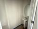 Bathroom featuring modern pedestal sink, round mirror, and neutral paint color at 82 W Emily Gardens Dr, Selma, NC 27576