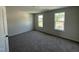 Bright bedroom with carpet flooring, neutral paint, and a large window overlooking a great view at 82 W Emily Gardens Dr, Selma, NC 27576