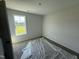 Cozy bedroom with a large window offering views of the surrounding landscape at 82 W Emily Gardens Dr, Selma, NC 27576