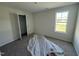 Bedroom with neutral walls, plush carpet, and a window with a view of the outdoors at 82 W Emily Gardens Dr, Selma, NC 27576