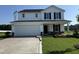 Charming two-story home with a two-car garage, manicured lawn, and stone accents at 82 W Emily Gardens Dr, Selma, NC 27576