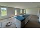 Open-concept kitchen features island with stainless appliances and abundant natural light at 82 W Emily Gardens Dr, Selma, NC 27576