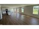 Open floor plan with wood floors and lots of windows and access to the kitchen with center island at 82 W Emily Gardens Dr, Selma, NC 27576