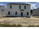 New two-story home featuring a back door and bright white siding awaiting yard completion at 82 W Emily Gardens Dr, Selma, NC 27577