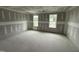 Bright bedroom displays drywall and two large windows, inviting natural light and style at 82 W Emily Gardens Dr, Selma, NC 27577