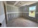 Bedroom during the construction phase with a window that offers natural light and outdoor views at 82 W Emily Gardens Dr, Selma, NC 27577