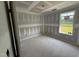 New bedroom showcasing the drywall-covered walls, trimmed windows allowing natural light and unfinished plywood flooring at 82 W Emily Gardens Dr, Selma, NC 27577