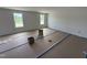 Spacious bedroom with large windows, neutral walls, and covered floors at 82 W Emily Gardens Dr, Selma, NC 27576