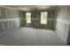 Bright unfinished bedroom features ample natural light and closet at 82 W Emily Gardens Dr, Selma, NC 27577