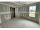 Unfinished bedroom featuring a scenic window view of trees and a lake, with drywall and trim at 82 W Emily Gardens Dr, Selma, NC 27577