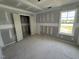 Unfinished bedroom area features closet and natural light at 82 W Emily Gardens Dr, Selma, NC 27577