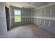 Bright bedroom with window looking out to a lush green yard during the construction phase at 82 W Emily Gardens Dr, Selma, NC 27577