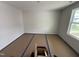 A bedroom with covered floors, light walls, bright window and electrical plugs at 82 W Emily Gardens Dr, Selma, NC 27576