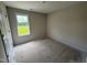 Bedroom with fresh paint, covered floors, electrical plugs, and bright window at 82 W Emily Gardens Dr, Selma, NC 27576