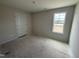 Cozy bedroom with a double door closet and a window overlooking a waterfront property at 82 W Emily Gardens Dr, Selma, NC 27576