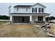 Charming two-story home with a convenient attached two-car garage and unfinished landscape at 82 W Emily Gardens Dr, Selma, NC 27577