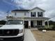 Two-story white home with black shutters, stone accents, and a newly installed yard at 82 W Emily Gardens Dr, Selma, NC 27576